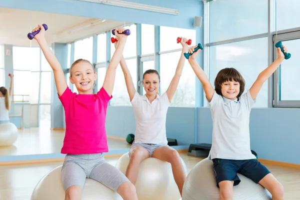 Mother and two children in health club