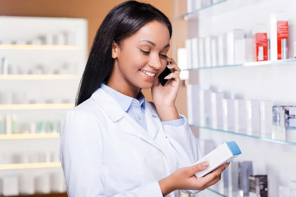 Woman talking on phone in drugstore