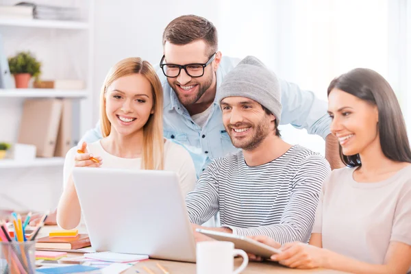 Business people looking at laptop