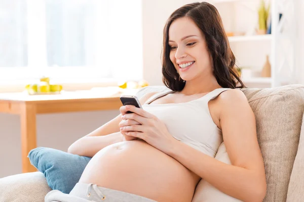 Pregnant woman holding mobile phone