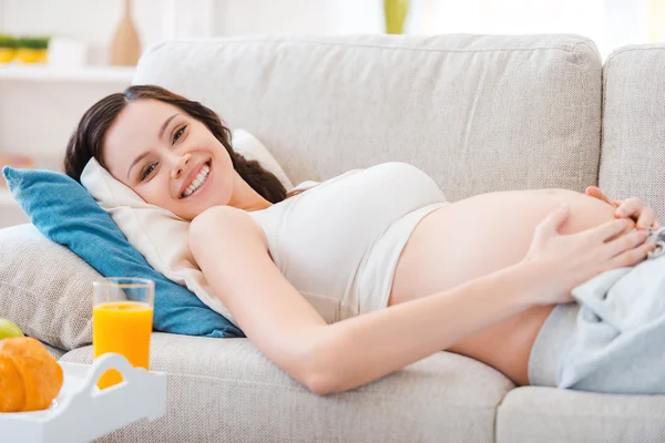Pregnant woman lying on couch