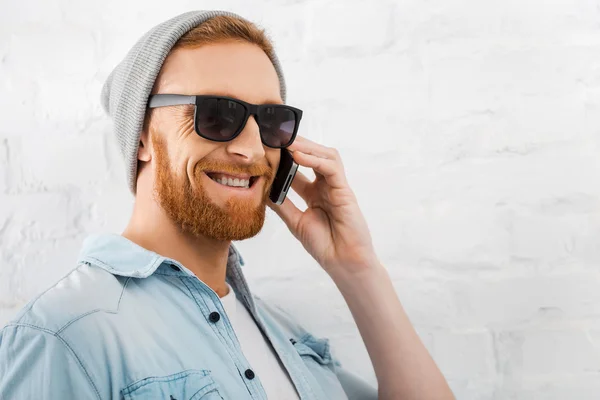 Bearded man talking on mobile phone