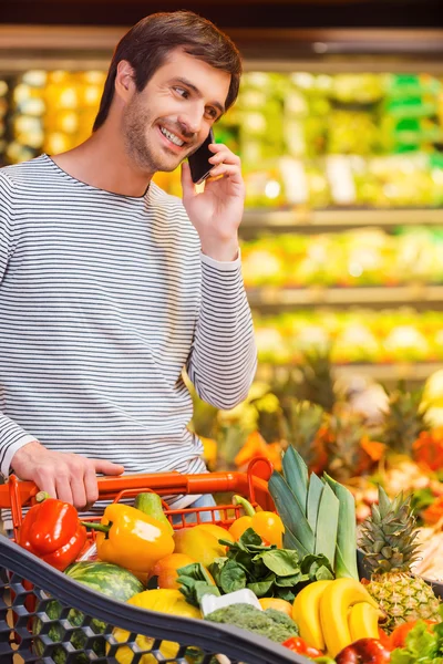 Man talking on mobile phone while shopping