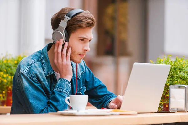 Man in headphones working on laptop