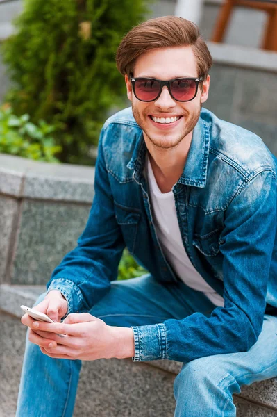 Smiling  man holding mobile phone