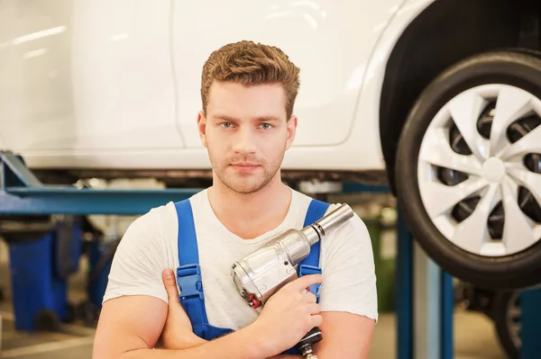 Man holding wrench in workshop