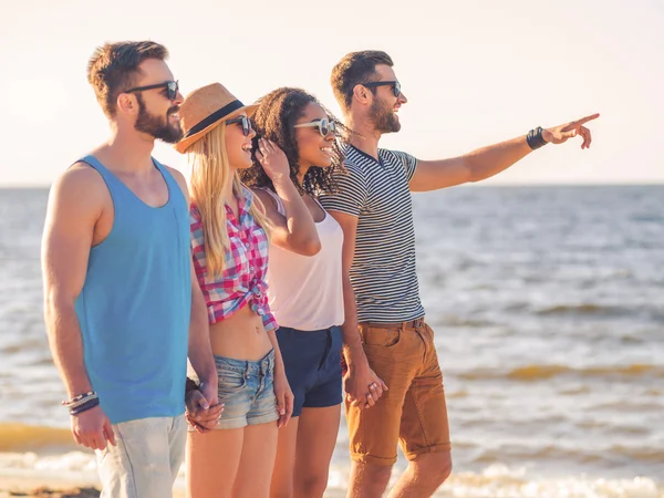 Young people walking along the beach