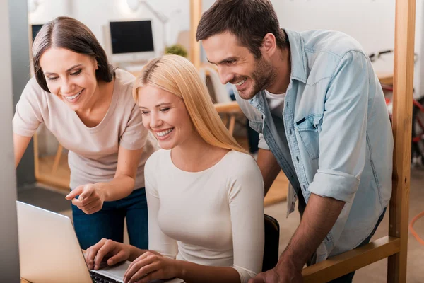 Business people looking at laptop