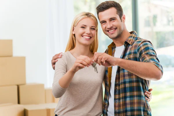 Couple holding keys in new house
