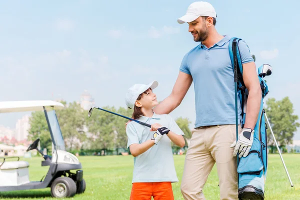 Man and his son on golf course