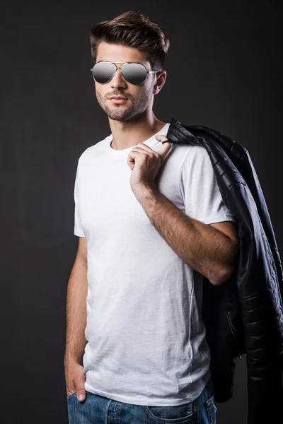 Man in sunglasses carrying his leather