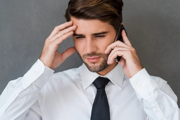 Frustrated man  talking on mobile phone