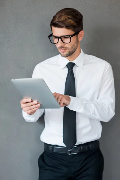 Man in shirt working on digital tablet