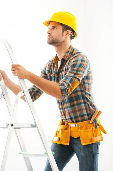 Crafts person climbing up ladder