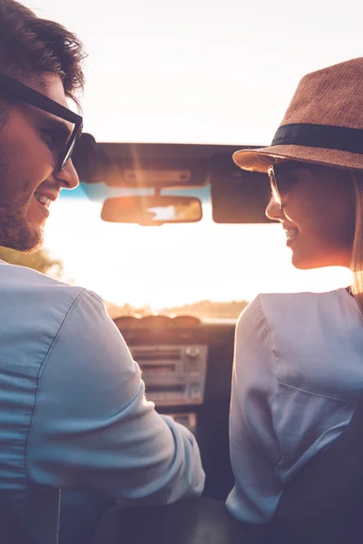 Couple looking at each other in convertible