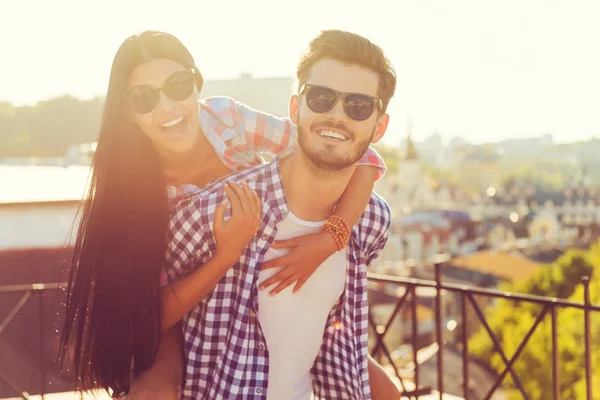 Man carrying his girlfriend on shoulders