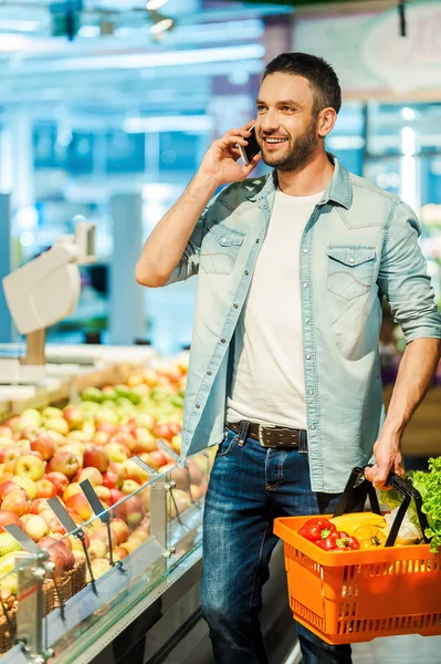 Man talking on mobile phone while shopping