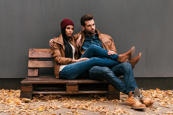 Couple bonding to each other on wooden pallet