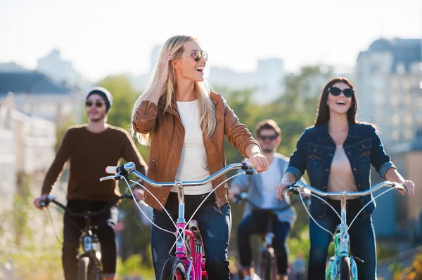 Woman riding bicycle with friends