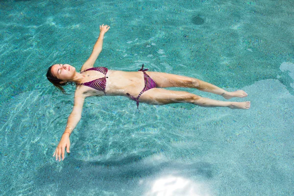 Floating woman in the pool