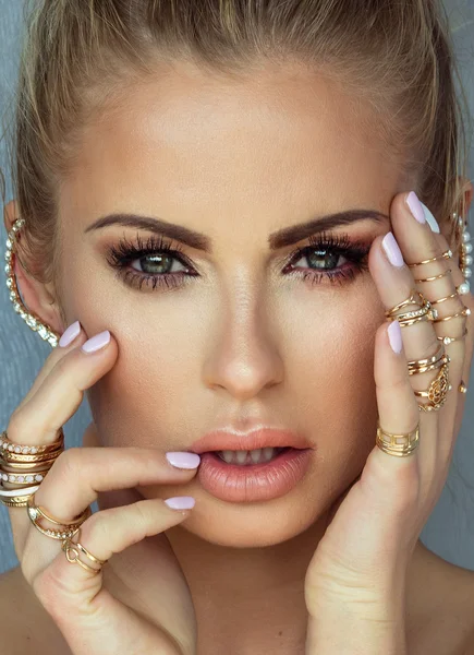 Beauty portrait of blonde woman with glamour makeup.
