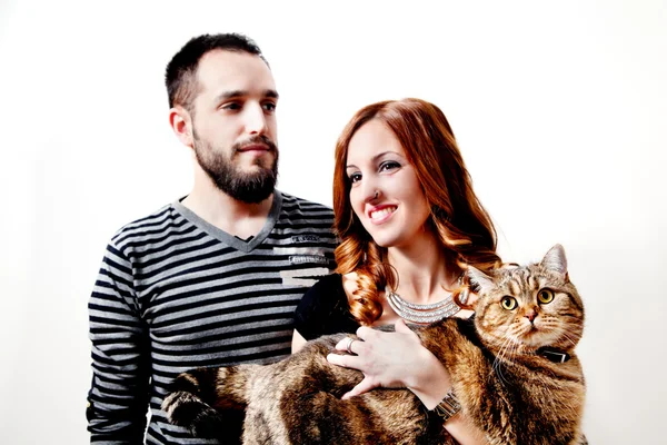 Young happy couple with her cat, pets.  Lifestyle