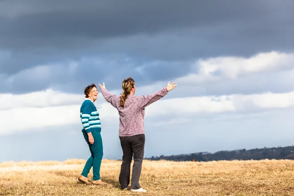 Women Walking Away Talking Outdoors