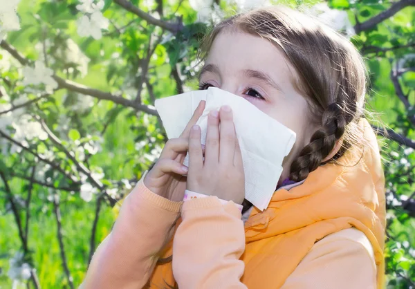 Child's flowers allergy.Girl sneezing.