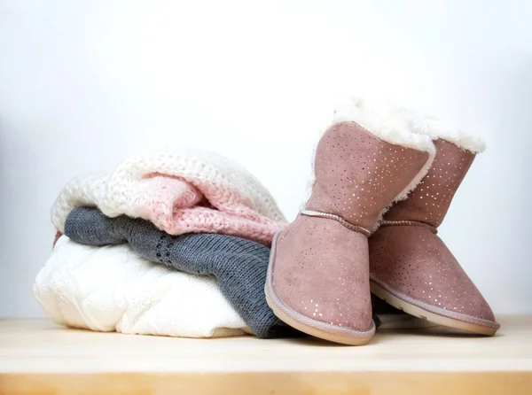 Winter clothes and shoes.Pair of uggs.