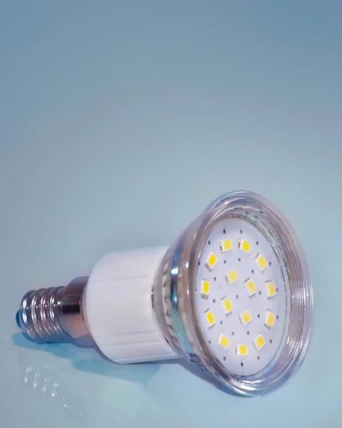 Led lamp closeup on blue background.Saving energy bulb.