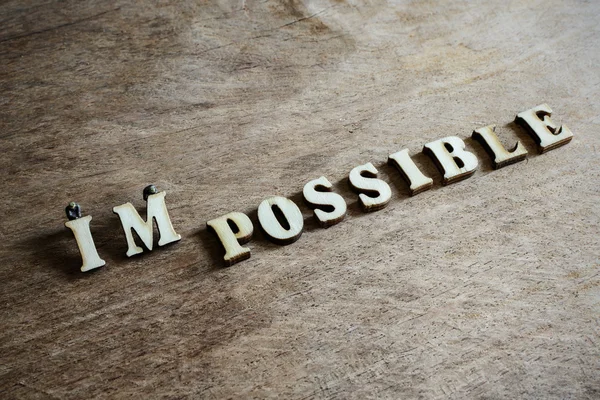 Worker moving on the word impossible to make the work possible