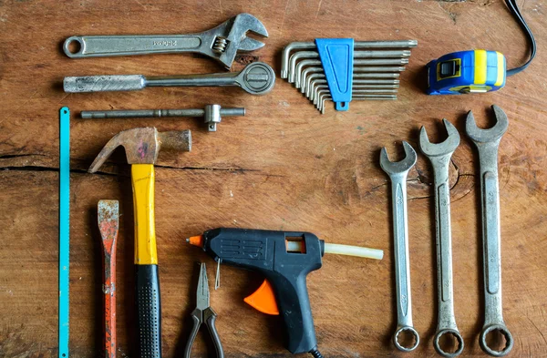 Set of work tools on old grunge wood background