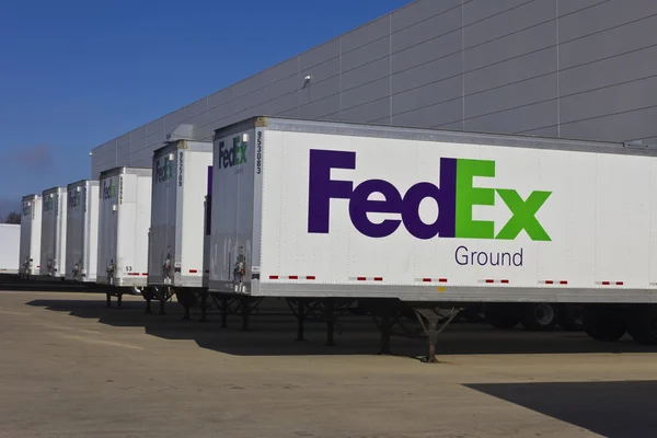 Indianapolis - Circa December 2015: Federal Express Trucks in Loading Docks. FedEx is a global courier delivery services company I