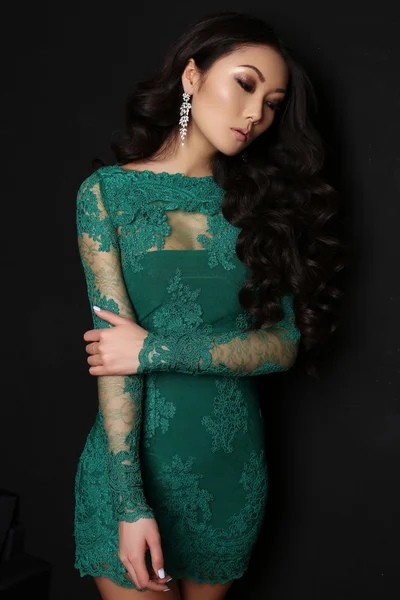 Sensual asian woman with long dark hair in elegant lace dress
