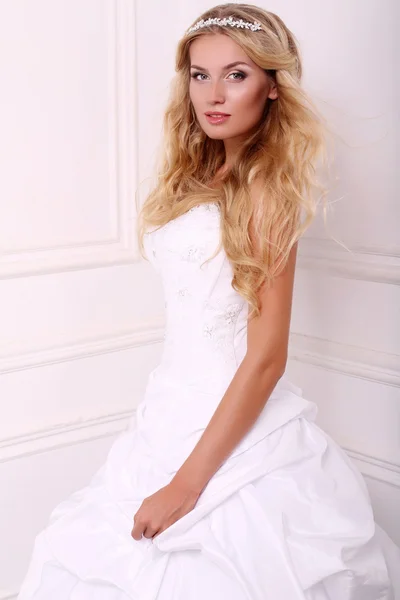 Beautiful bride with blond hair in wedding dress