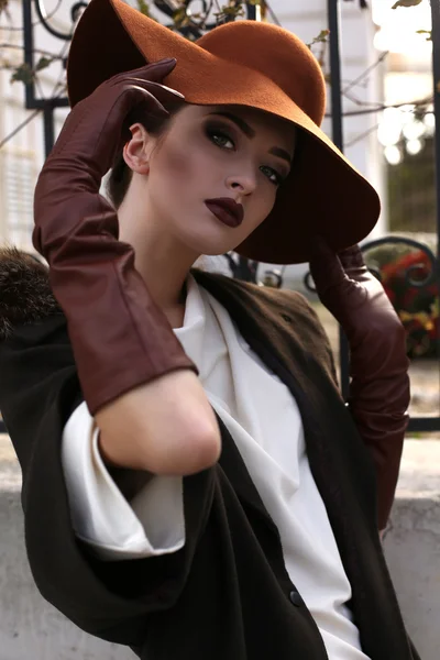 Beautiful portrait of ladylike woman in elegant coat and hat