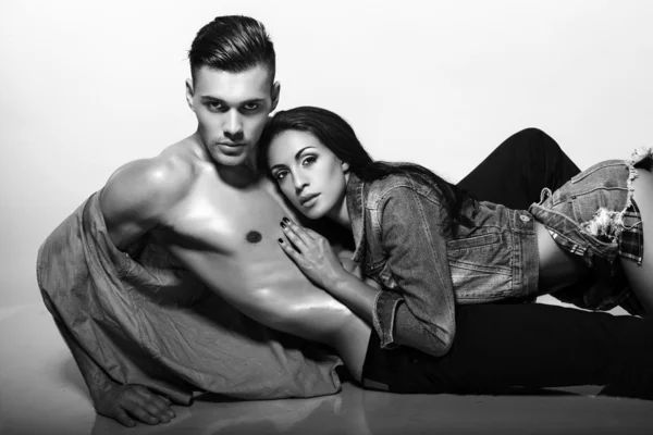 Sexy impassioned couple in jeans clothes posing in studio