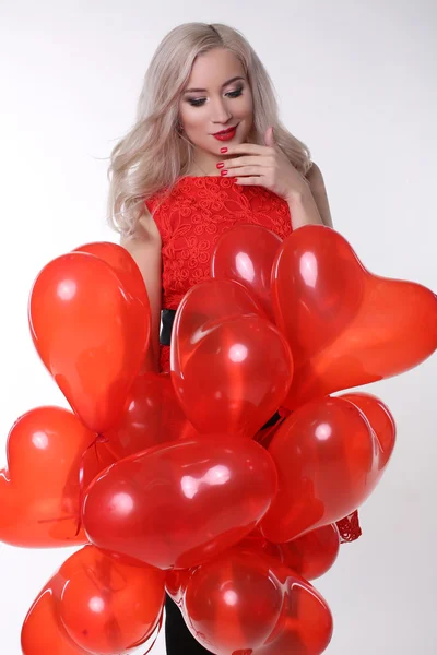 Valentine\'s day. Beautiful woman with red air balloons