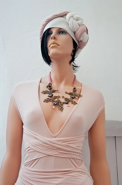 The mannequin in pink dress with original necklace
