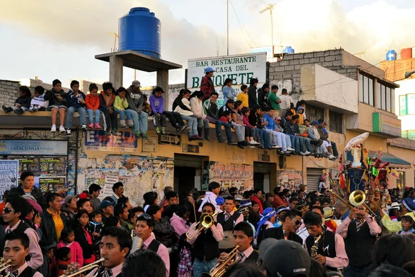 Onlookers are watching La Fiesta de la Mama Negra traditional festival