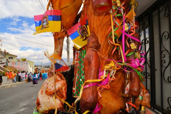 Pig adorned with fruits, spirits, flags and guinea pigs at La Fiesta de la Mama Negra traditional festival