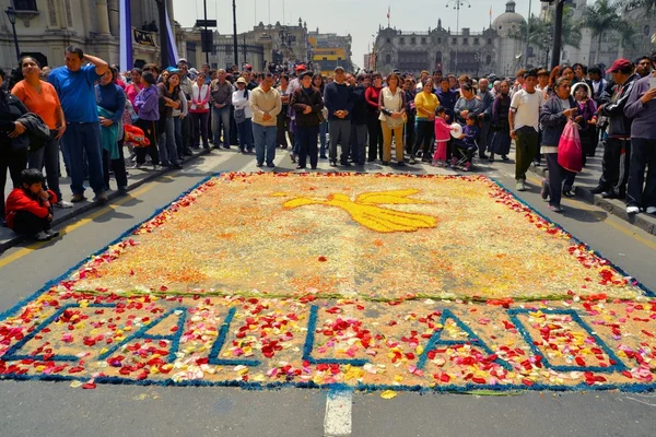 Colorful ground paintings at Lord of Miracles catholic religious procession during purple month in Lima, Peru