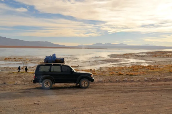 Tourist jeep at hot springs in Southwestern Bolivia near Uyuni