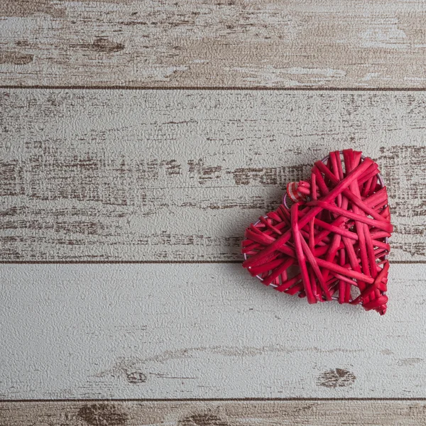 Red wood heart on wooden background