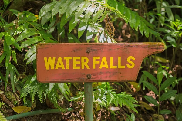 Wooden signpost to the waterfall