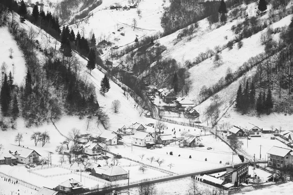 Winter mountain landscape with villages. Black and white photography