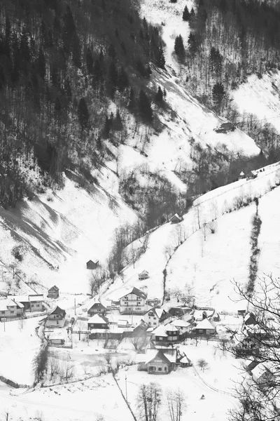 Winter mountain landscape with villages. Black and white photography