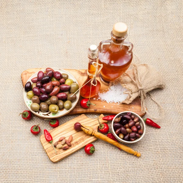 Composition with olive wood, olives, vinegar and spices with burlap texture