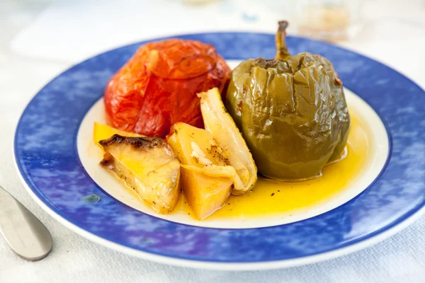 Stuffed vegetables and sauce on a blue plate