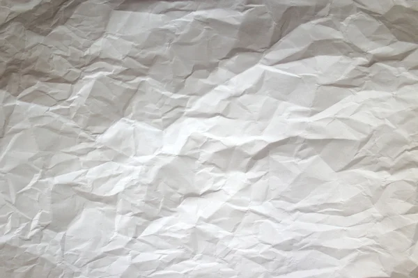 A crumpled sheet of heavy paper